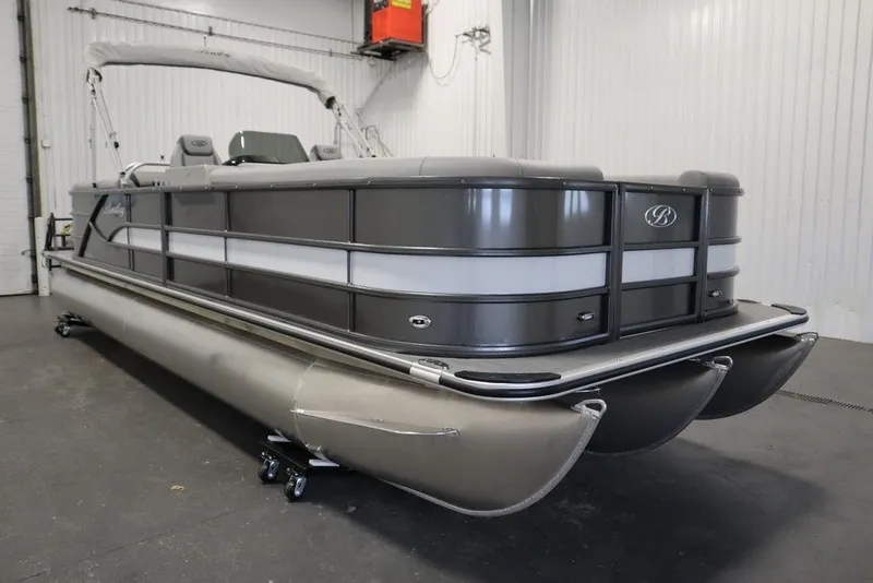 Slide: The Image of 2025 Bentley Pontoons 243 Navigator Tri-toon in a showroom, showcasing sleek design and luxury features. - 2