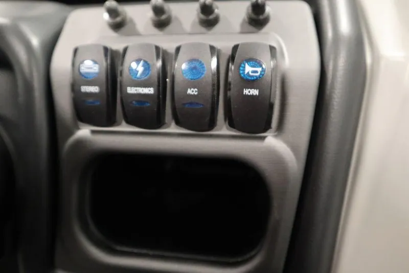 Slide: The Image of Control panel of 2025 Bentley Pontoons 243 Navigator Tri-toon with labeled switches. - 22