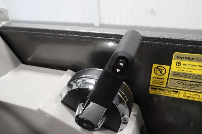 Slide: The Image of Throttle control of 2025 Bentley Pontoons 243 Navigator Tri-toon, with capacity warning label. - 24