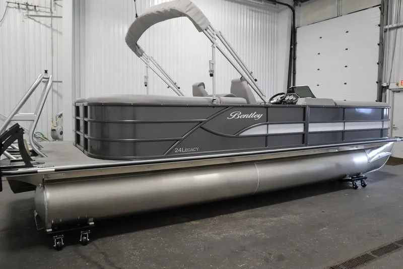 Slide: The Image of 2025 Bentley Pontoons 243 Navigator Tri-toon in a garage, showcasing sleek design and modern features. - 3