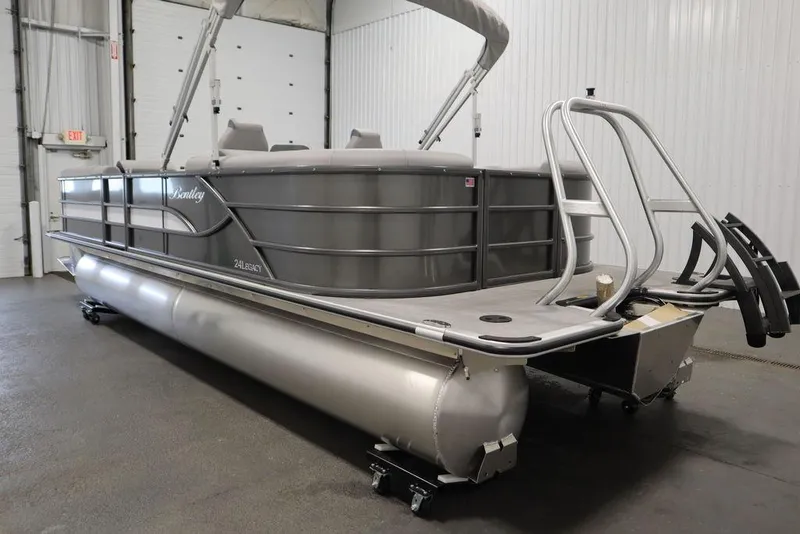 Slide: The Image of 2025 Bentley Pontoons 243 Navigator Tri-toon in a showroom, showcasing sleek design and modern features. - 5