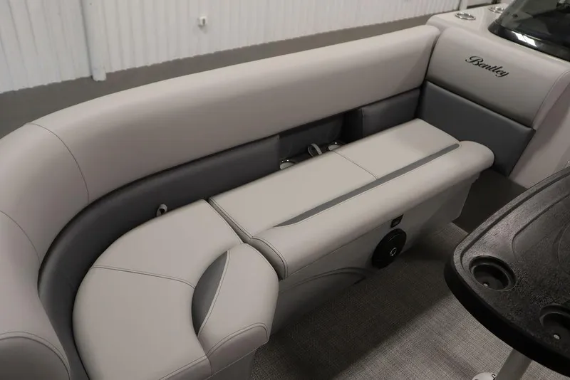Slide: The Image of 2025 Bentley Pontoons 243 Navigator Tri-toon interior seating, featuring luxurious gray upholstery. - 7