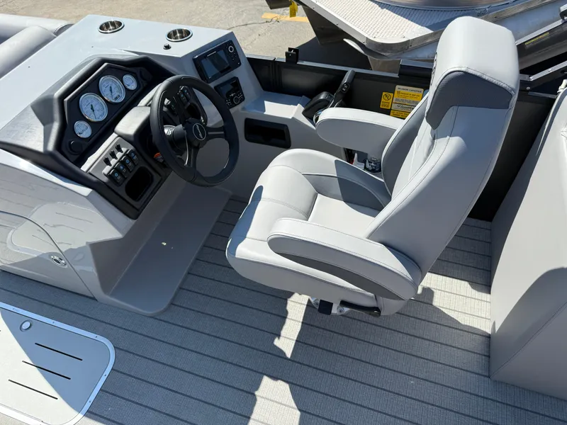 Slide: The Image of 2026 Bentley Pontoons Legacy 223 Navigator helm with modern controls and comfortable captain's chair. - 13