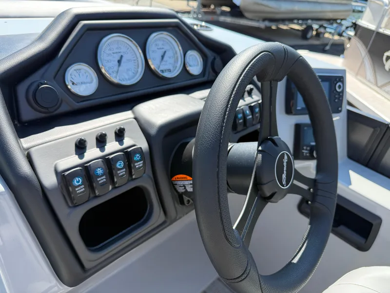 Slide: The Image of Steering console of 2026 Bentley Pontoons Legacy 223 Navigator with gauges and controls. - 14