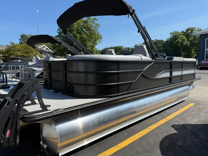Slide: The Image of 2026 Bentley Pontoons Legacy 223 Navigator, sleek design, docked outdoors. - 2