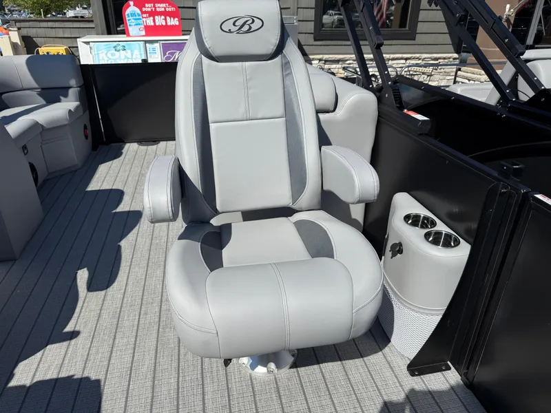 Slide: The Image of Captain's chair on 2026 Bentley Pontoons Legacy 223 Navigator, featuring cup holders and sleek design. - 21