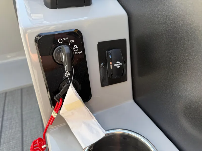 Slide: The Image of Control panel of 2026 Bentley Pontoons Legacy 223 Navigator with ignition and Bimini top switch. - 28