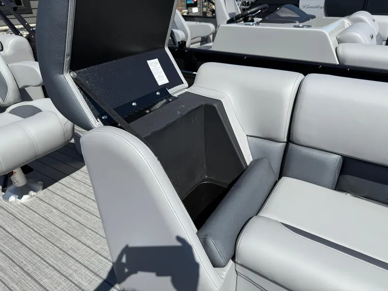 Slide: The Image of 2026 Bentley Pontoons Legacy 223 Navigator seat storage compartment, open on a luxury boat. - 32