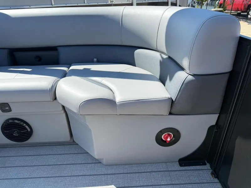 Slide: The Image of 2026 Bentley Pontoons Legacy 223 Navigator interior seating with gray upholstery and speaker. - 9