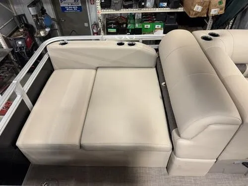 Slide: The Image of 2025 Sun Tracker Sportfish 24 XP3 boat interior with beige seating and cup holders. - 10