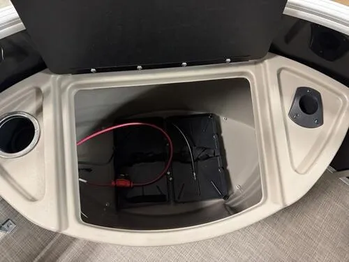 Slide: The Image of 2025 Sun Tracker Sportfish 24 XP3 storage compartment with cup holders and wiring. - 13