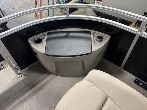 Slide: The Image of 2025 Sun Tracker Sportfish 24 XP3 boat interior with seating and storage area. - 14