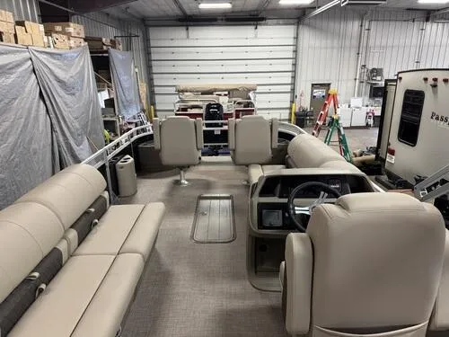 Slide: The Image of 2025 Sun Tracker Sportfish 24 XP3 pontoon boat interior in a garage setting. - 17
