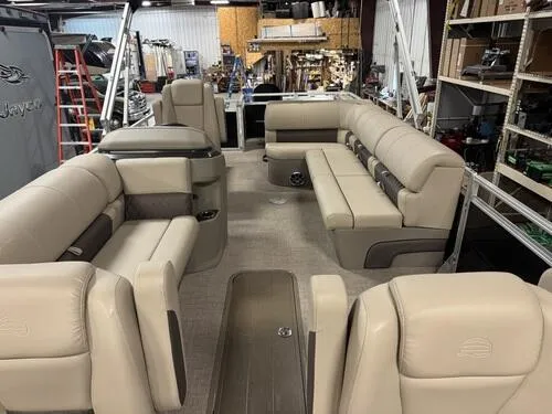 Slide: The Image of 2025 Sun Tracker Sportfish 24 XP3 pontoon boat interior with beige seating. - 18