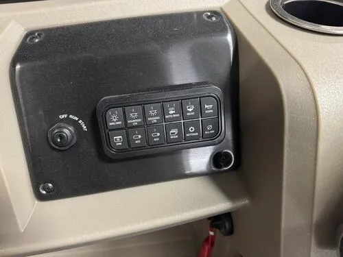 Slide: The Image of Control panel of 2025 Sun Tracker Sportfish 24 XP3 boat with various switches. - 7