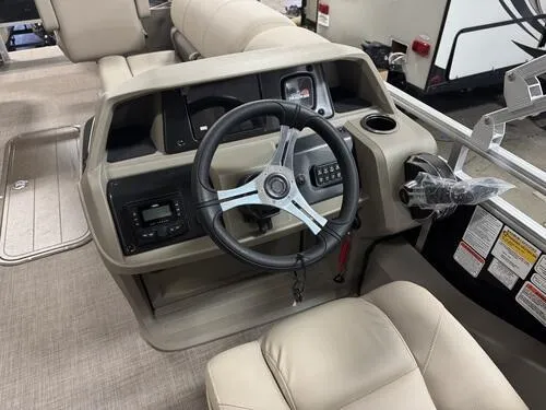 Slide: The Image of 2025 Sun Tracker Sportfish 24 XP3 boat interior with steering wheel and control panel. - 9