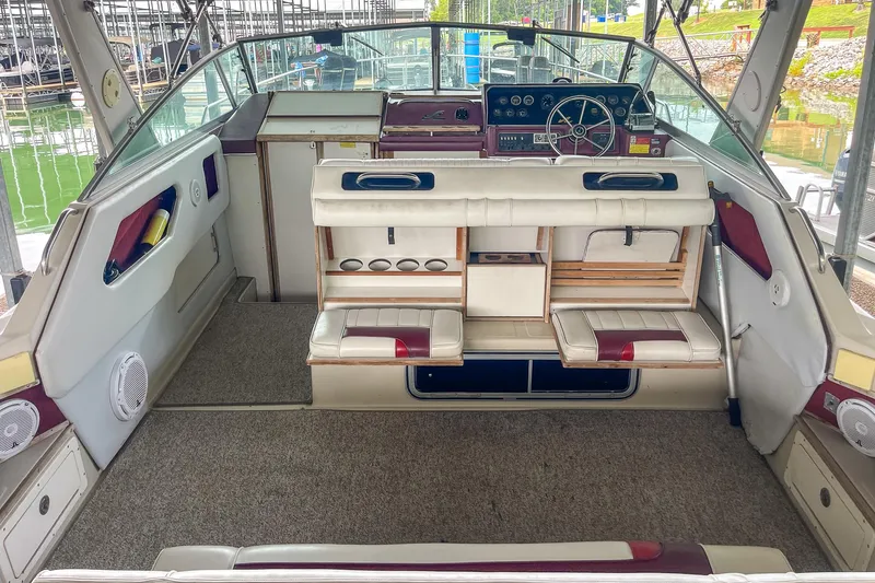 Slide: The Image of 1987 Sea Ray 300 Sundancer boat interior with helm, seating, and dashboard controls. - 10