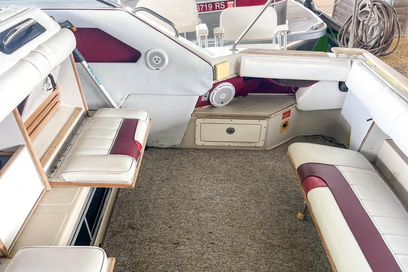 Slide: The Image of Interior of a 1987 Sea Ray 300 Sundancer boat with white and red seating. - 13