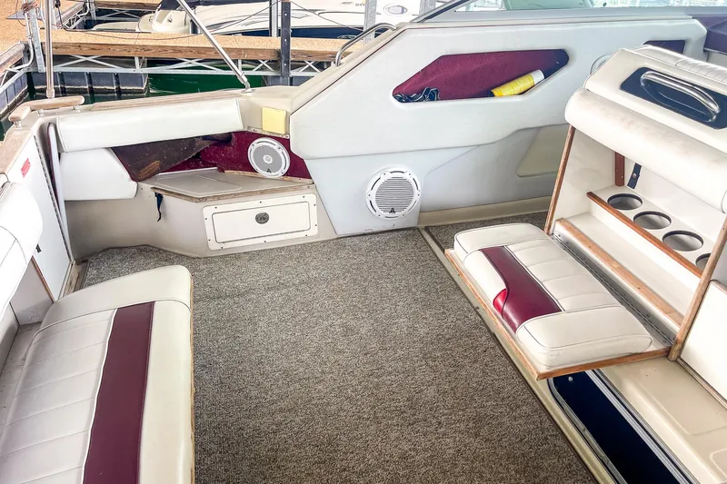 Slide: The Image of Interior of a 1987 Sea Ray 300 Sundancer boat with seating and storage compartments. - 14