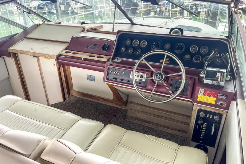 Slide: The Image of 1987 Sea Ray 300 Sundancer helm with vintage controls and steering wheel. - 18