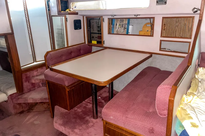 Slide: The Image of Interior of 1987 Sea Ray 300 Sundancer with dining area and pink upholstery. - 26