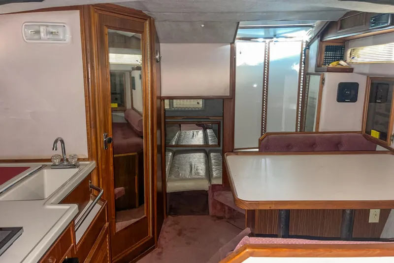 Slide: The Image of Interior of 1987 Sea Ray 300 Sundancer boat with kitchenette and dining area. - 29
