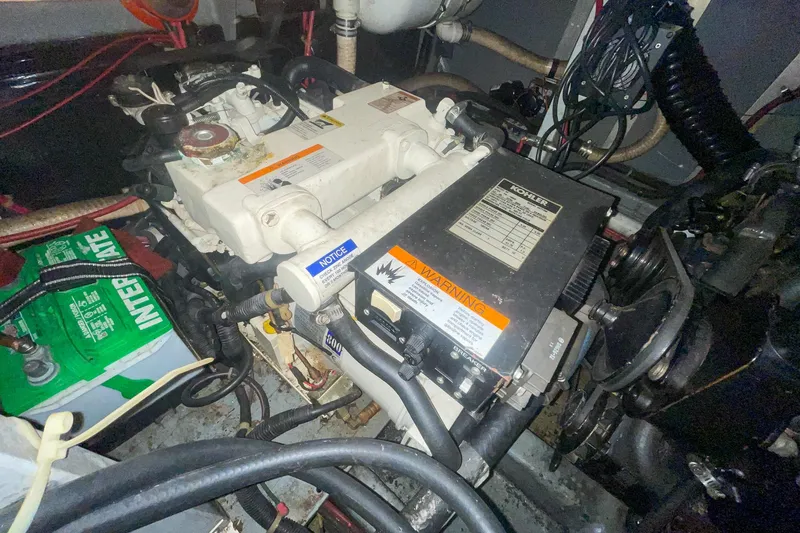 Slide: The Image of Engine compartment of a 1987 Sea Ray 300 Sundancer with visible battery and wiring. - 34