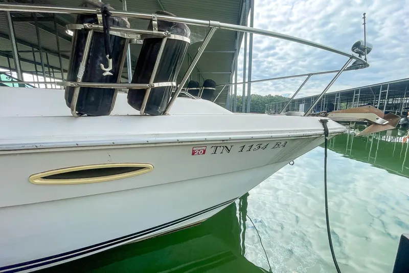 Slide: The Image of 1987 Sea Ray 300 Sundancer docked, displaying registration number TN 1134 BA. - 4