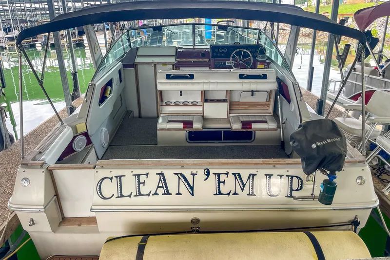 Slide: The Image of 1987 Sea Ray 300 Sundancer boat docked, featuring "CLEAN 'EM UP" on the stern. - 9