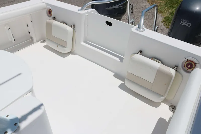 Slide: The Image of 2006 ProKat 2360 Center Console boat interior with seating and Yamaha 150 engines. - 10