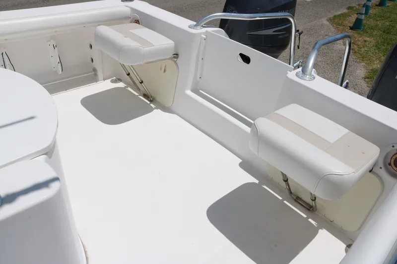Slide: The Image of 2006 ProKat 2360 Center Console boat interior with foldable seating. - 11