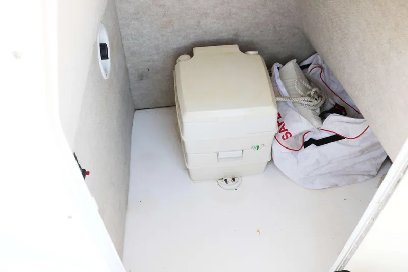 Slide: The Image of Storage compartment in 2006 ProKat 2360 Center Console with portable toilet and safety gear. - 14