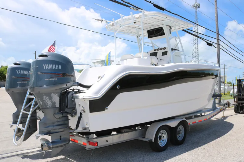 Slide: The Image of 2006 ProKat 2360 Center Console boat with twin Yamaha engines on a trailer. - 3