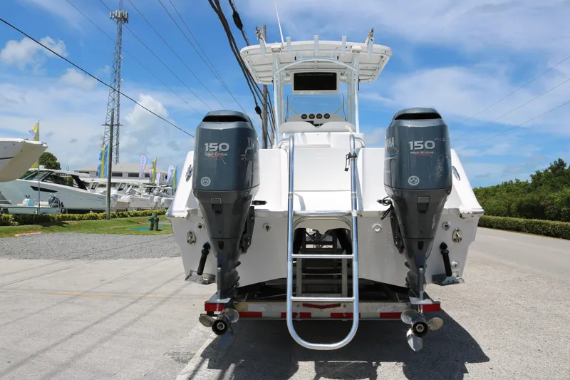 Slide: The Image of 2006 ProKat 2360 Center Console boat with dual Yamaha 150 engines, parked outdoors. - 4