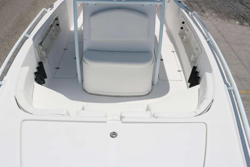 Slide: The Image of 2006 ProKat 2360 Center Console boat interior with white seating and storage compartments. - 8