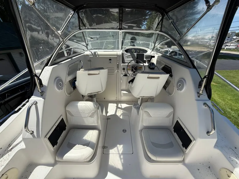 Slide: The Image of 2002 Boston Whaler 255 Conquest boat interior with helm and seating. - 10