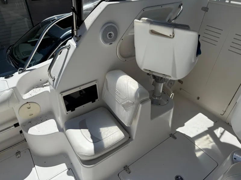 Slide: The Image of 2002 Boston Whaler 255 Conquest interior with white seating and helm area. - 11