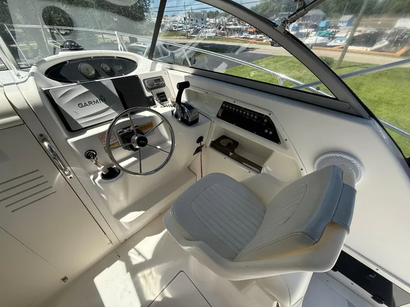 Slide: The Image of 2002 Boston Whaler 255 Conquest helm with Garmin navigation and steering wheel. - 13
