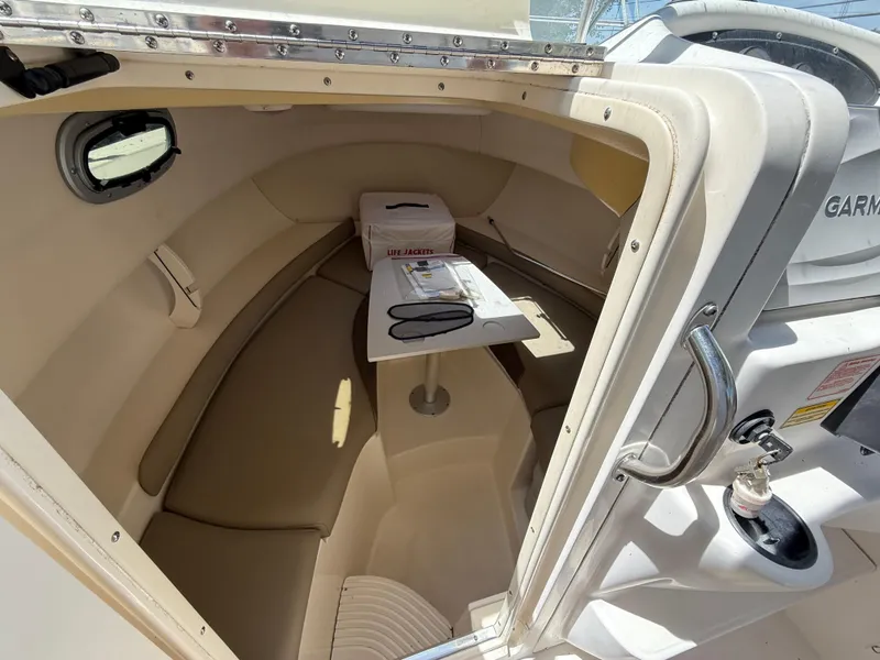 Slide: The Image of 2002 Boston Whaler 255 Conquest cabin interior with seating and table. - 18