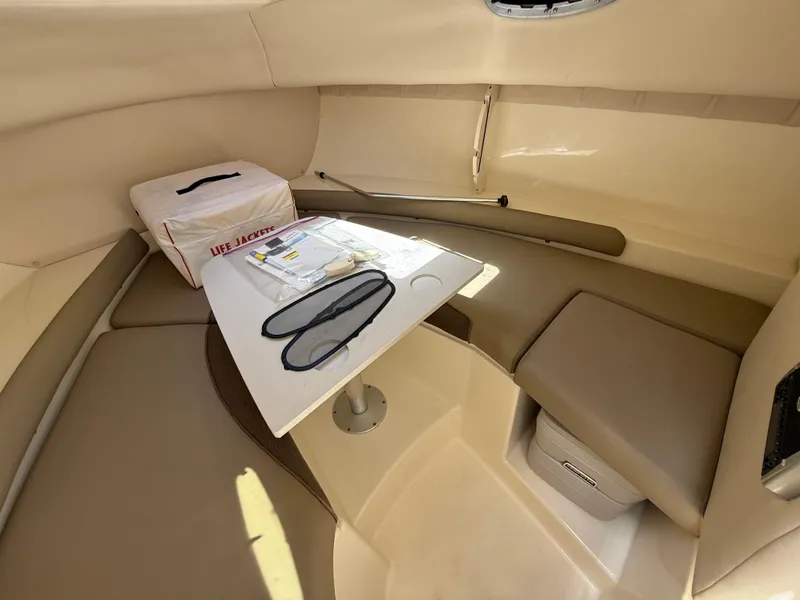 Slide: The Image of Interior cabin of 2002 Boston Whaler 255 Conquest with table and life jackets. - 20