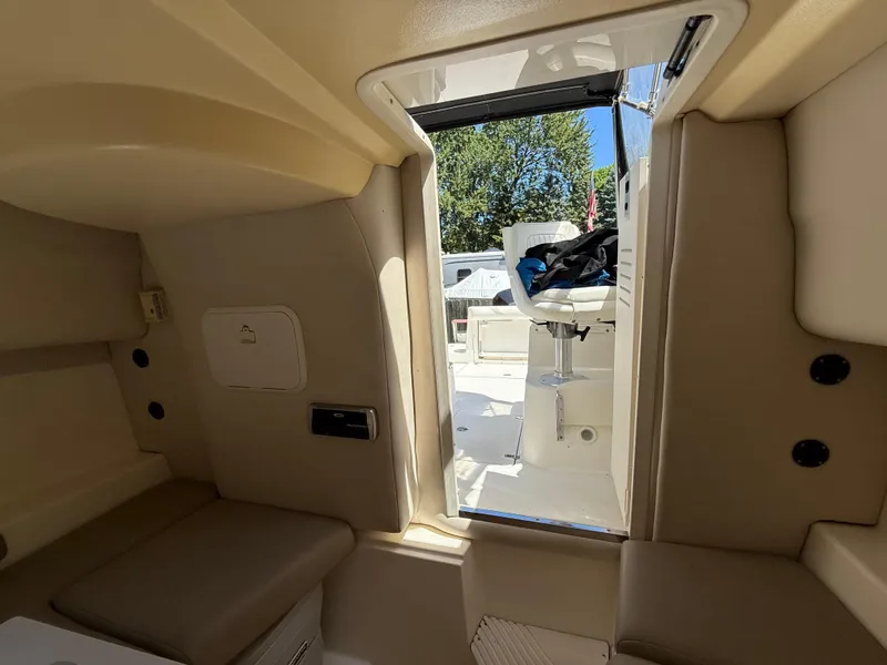 Slide: The Image of Interior view of 2002 Boston Whaler 255 Conquest boat cabin and seating area. - 21