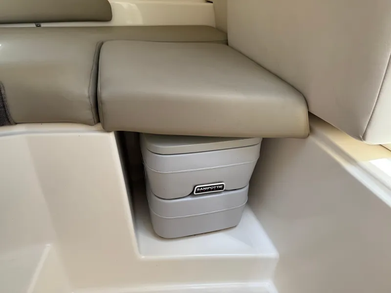 Slide: The Image of 2002 Boston Whaler 255 Conquest interior with Sanipottie under seat storage. - 22