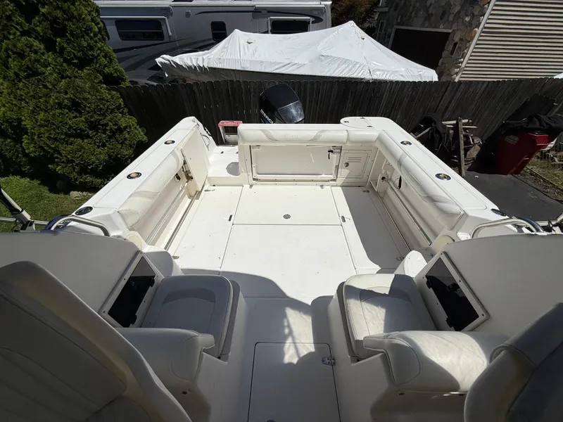 Slide: The Image of 2002 Boston Whaler 255 Conquest boat interior with white seating and spacious deck. - 24