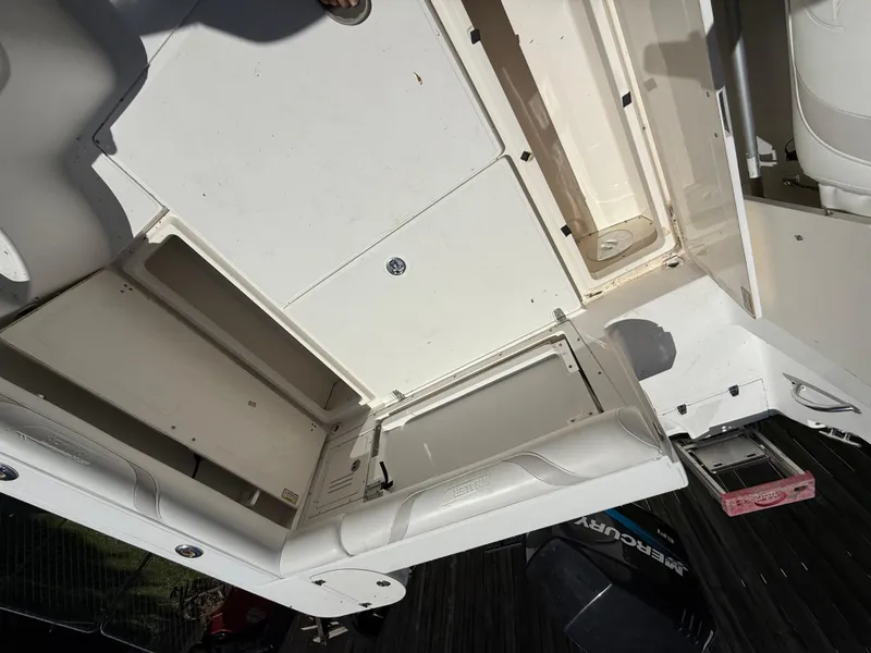 Slide: The Image of 2002 Boston Whaler 255 Conquest boat interior with open storage compartments. - 32