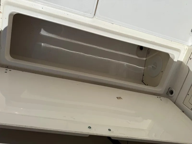 Slide: The Image of Open storage compartment on a 2002 Boston Whaler 255 Conquest boat. - 33