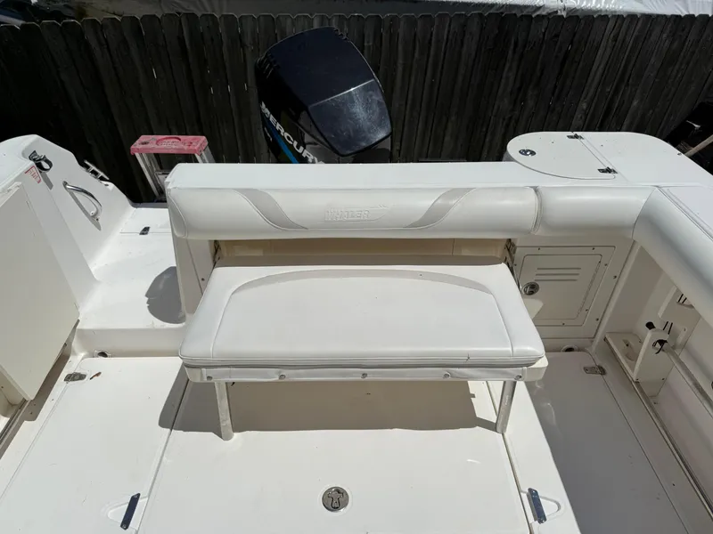 Slide: The Image of 2002 Boston Whaler 255 Conquest boat interior with seating and Mercury outboard motor. - 34