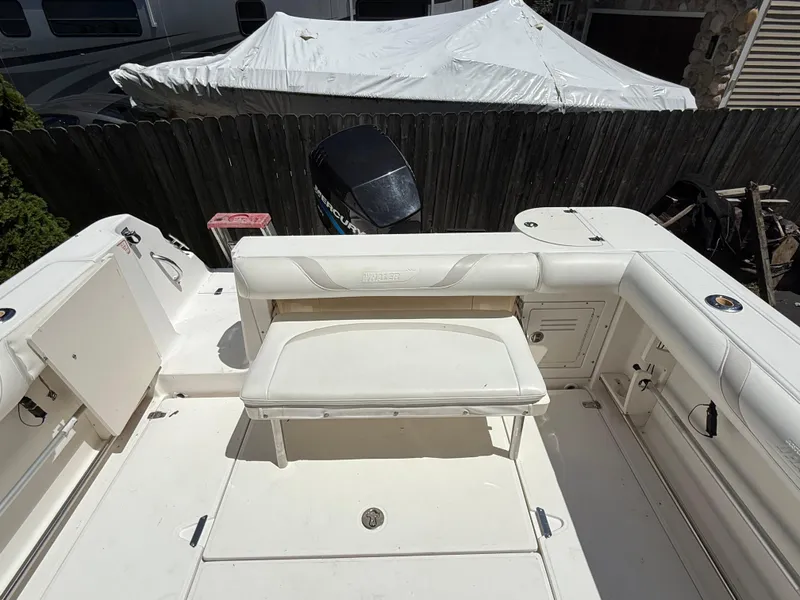 Slide: The Image of 2002 Boston Whaler 255 Conquest boat interior with seating and engine view. - 35