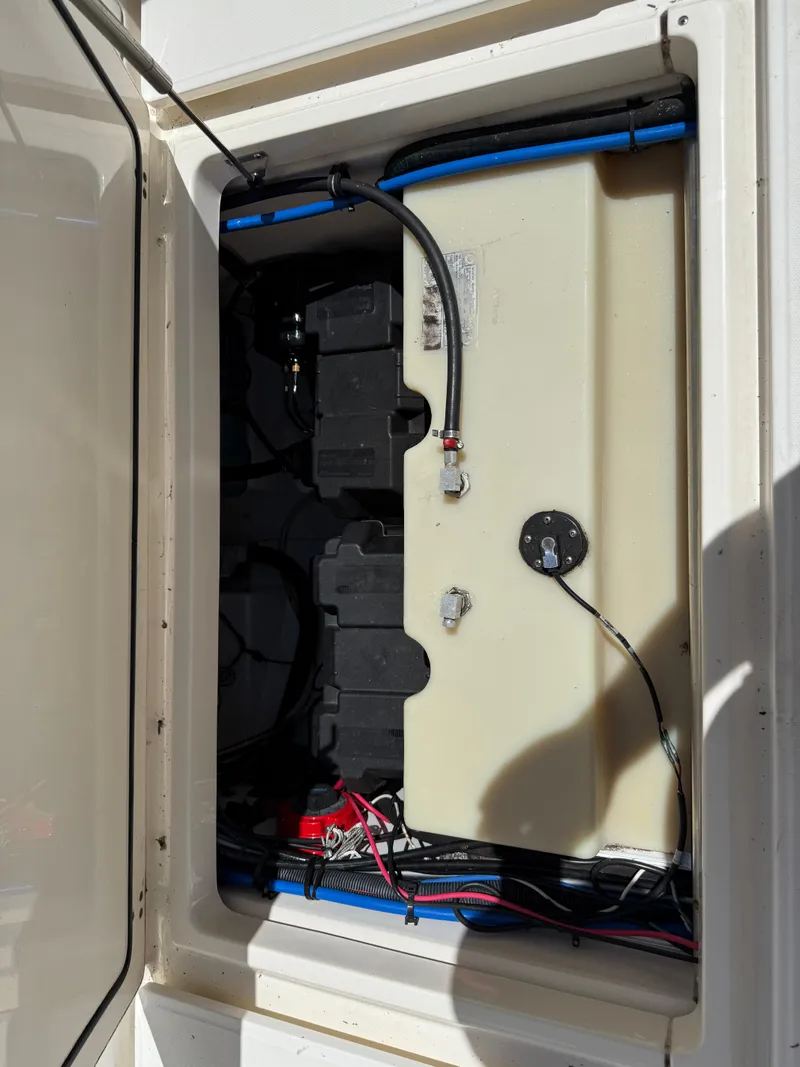 Slide: The Image of 2002 Boston Whaler 255 Conquest battery compartment with wiring and components. - 36