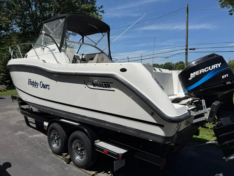 Slide: The Image of 2002 Boston Whaler 255 Conquest boat on trailer with Mercury EFI engine. - 4