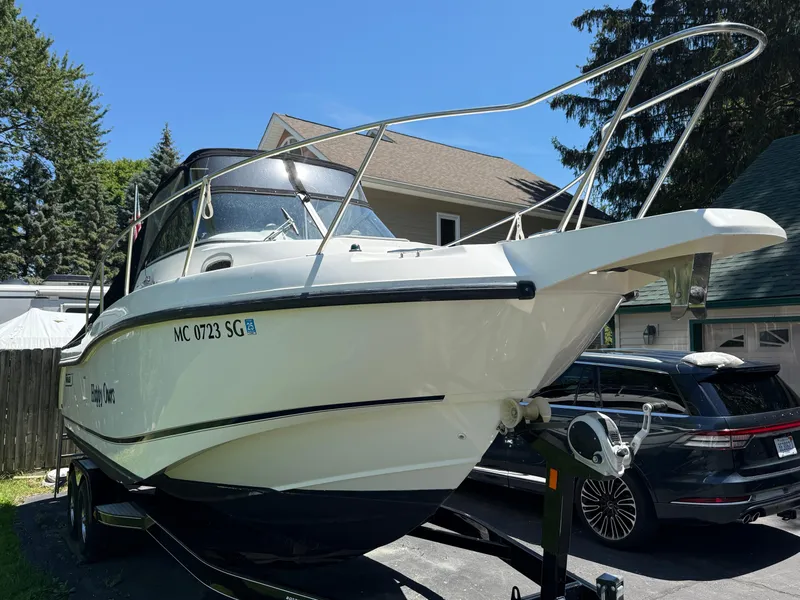 Slide: The Image of 2002 Boston Whaler 255 Conquest boat on trailer, parked in driveway. - 41